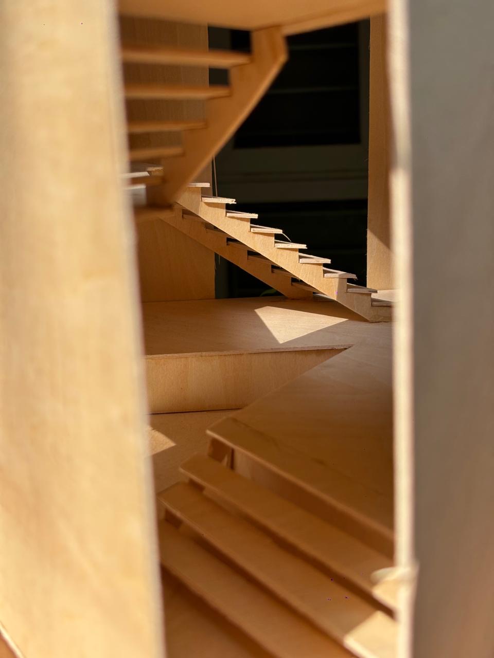 Inside, the stair climbs between the fins.